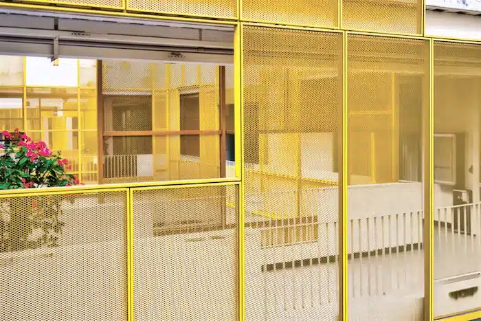Perforated aluminum safety facade-yellow